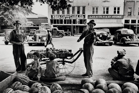 Melon Salesman And Fidler At a Marketplace in Scott, Mississippi Photography - Alfred Eisenstaedt